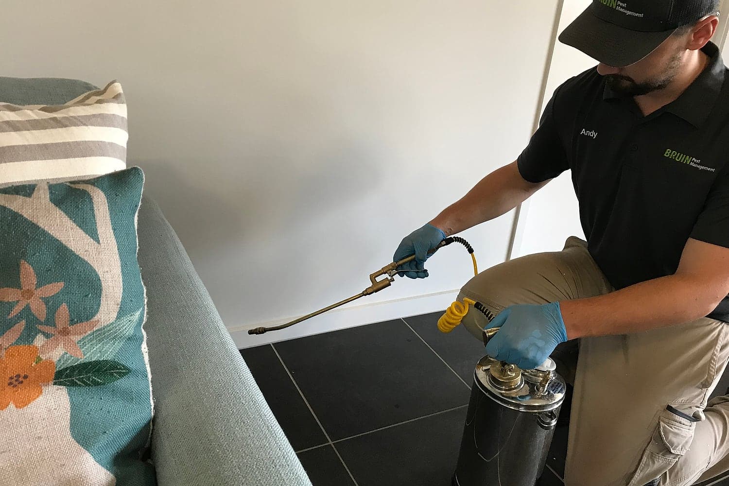 Bruin technician carrying out a general pest treatment inside a home